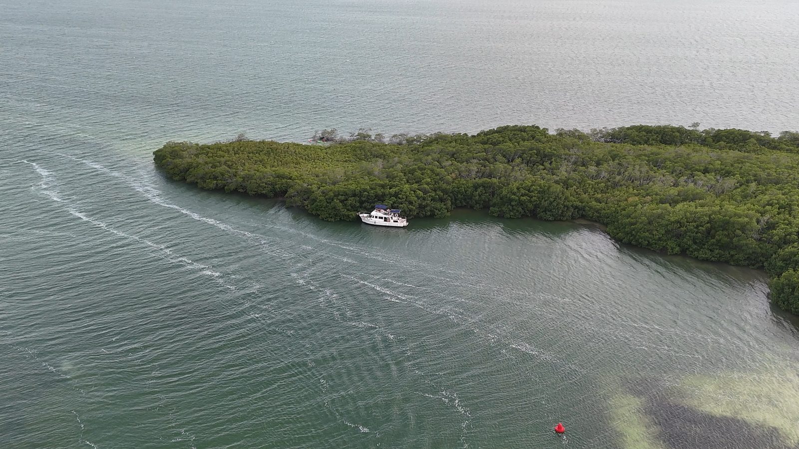 Aerial view of the Tafil cruising past a mangrove island in Laguna Nichupté