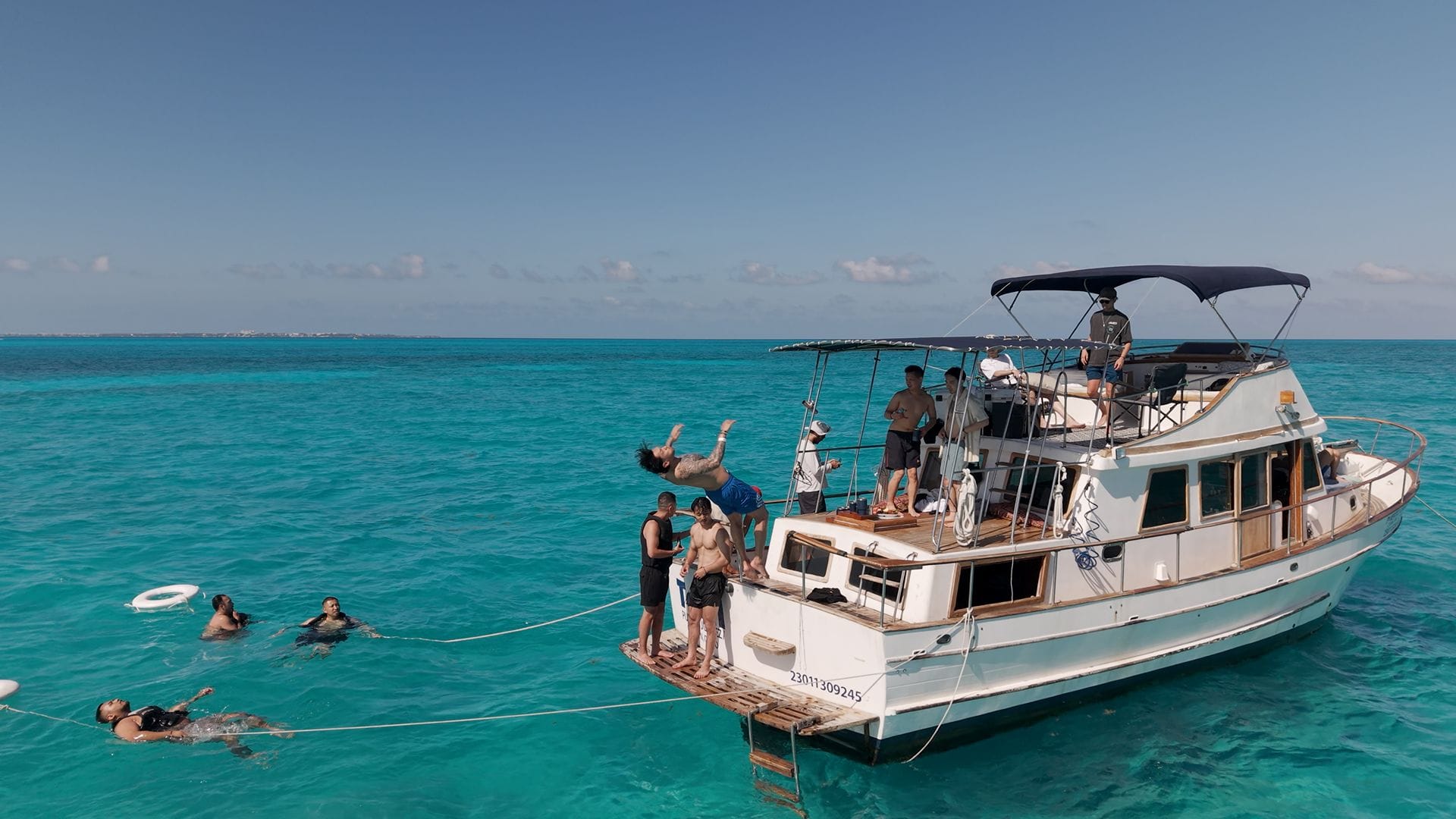 Guests swimming off the stern of the Tafil in the turquoise water of the Arenales