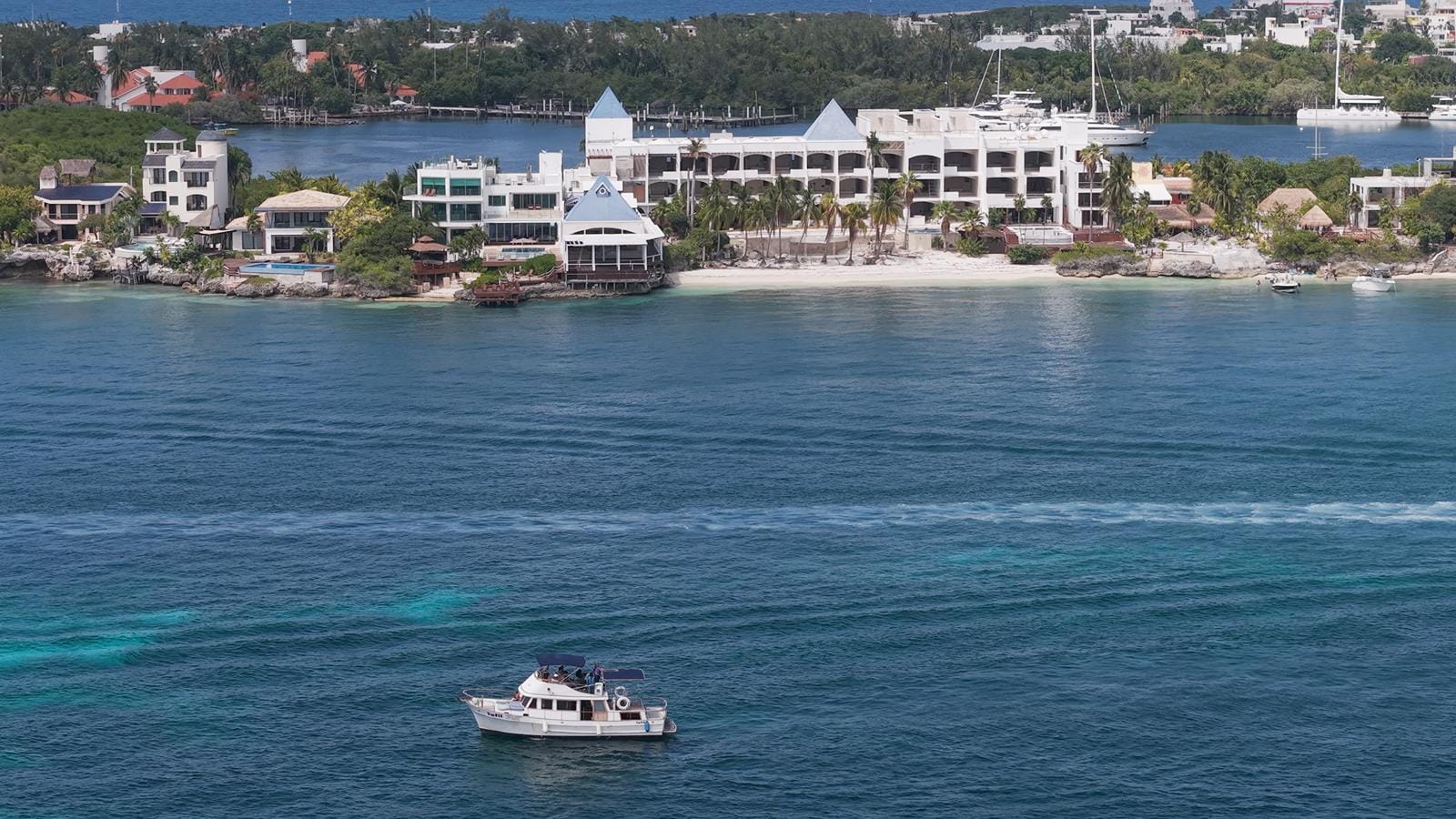The Tafil cruising past the white villas on the western shore of Isla Mujeres