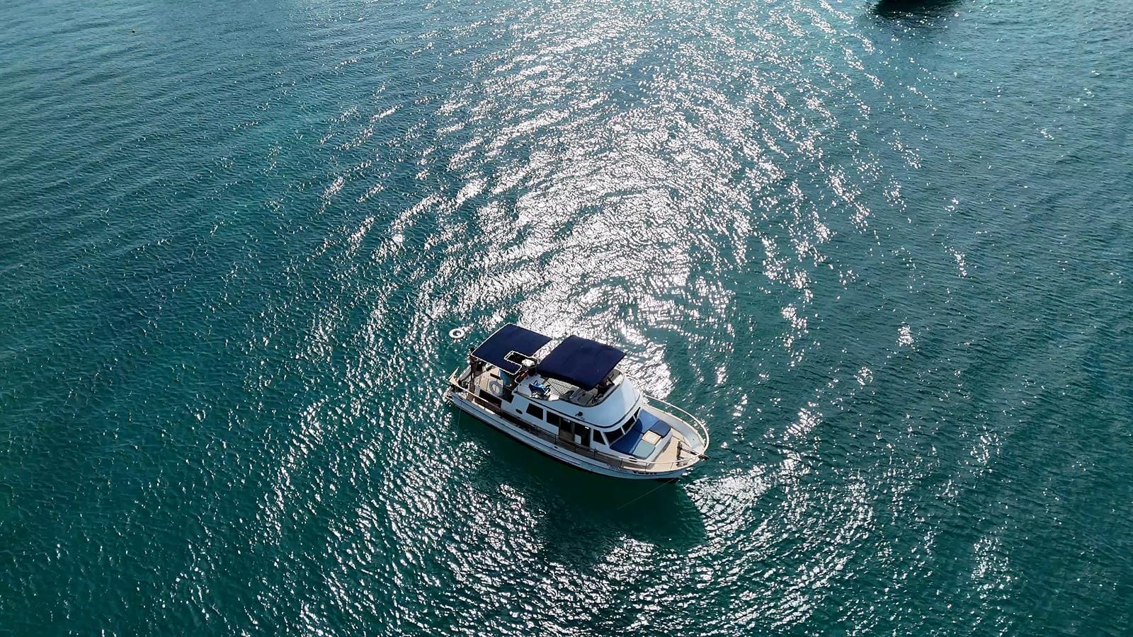 Top-down view of the Tafil in the deep blue-green water off Punta Cancún