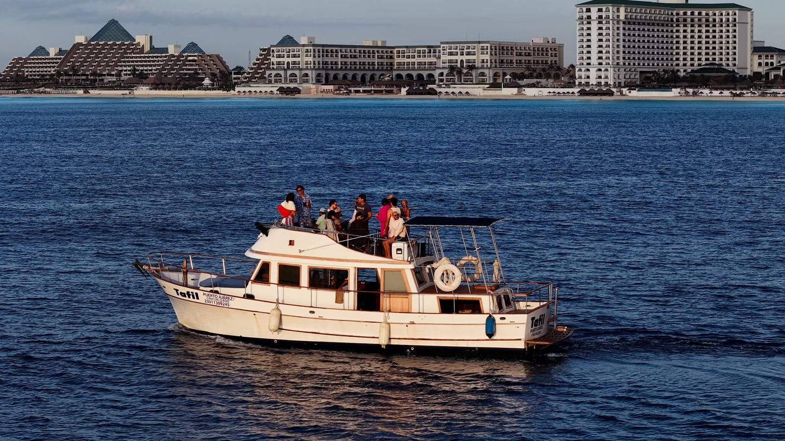The Tafil cruising along the Caribbean side of the Hotel Zone with hotels behind