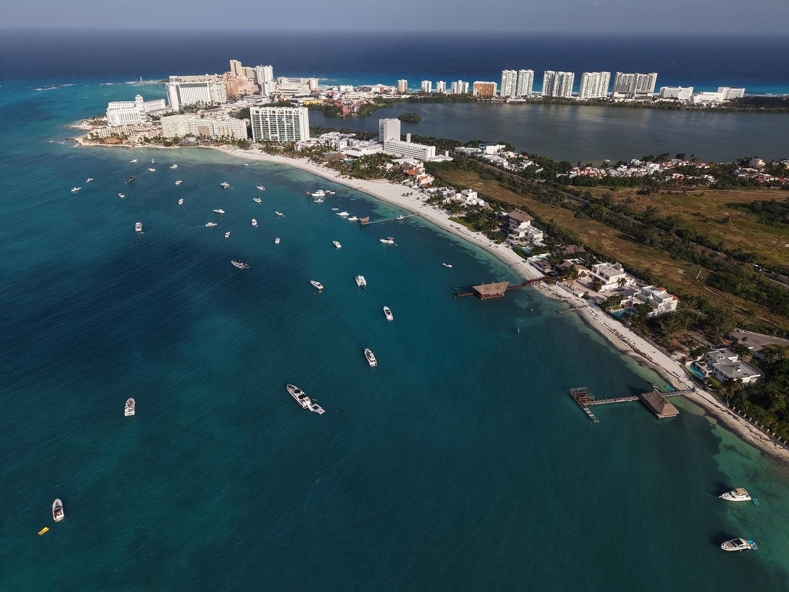 Aerial view of Punta Cancún and the Hotel Zone strip with boats in the bay