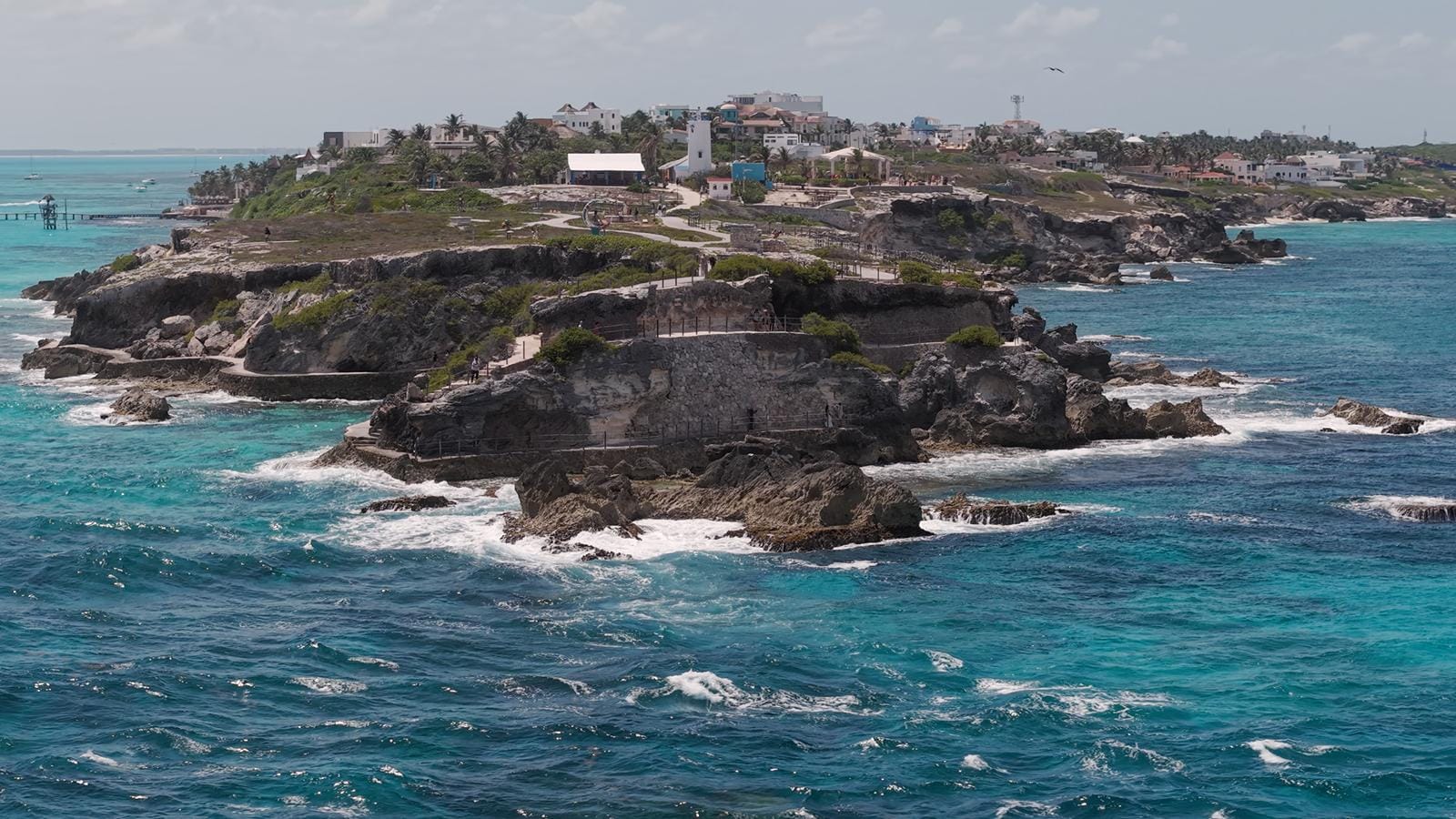 Aerial view of the rocky cliffs of Punta Sur with waves breaking below