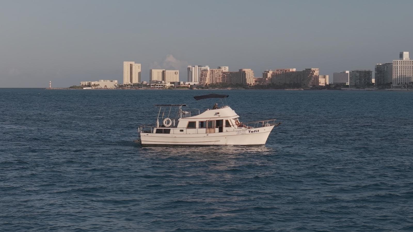 The Tafil at sea with the Cancún skyline on the horizon