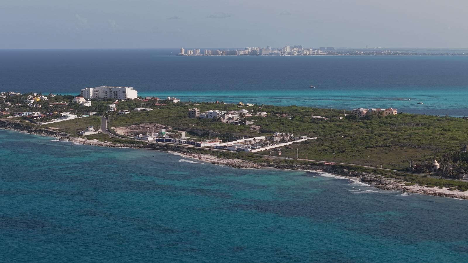 Aerial view of the Isla Mujeres east coast with turquoise shallows and open ocean