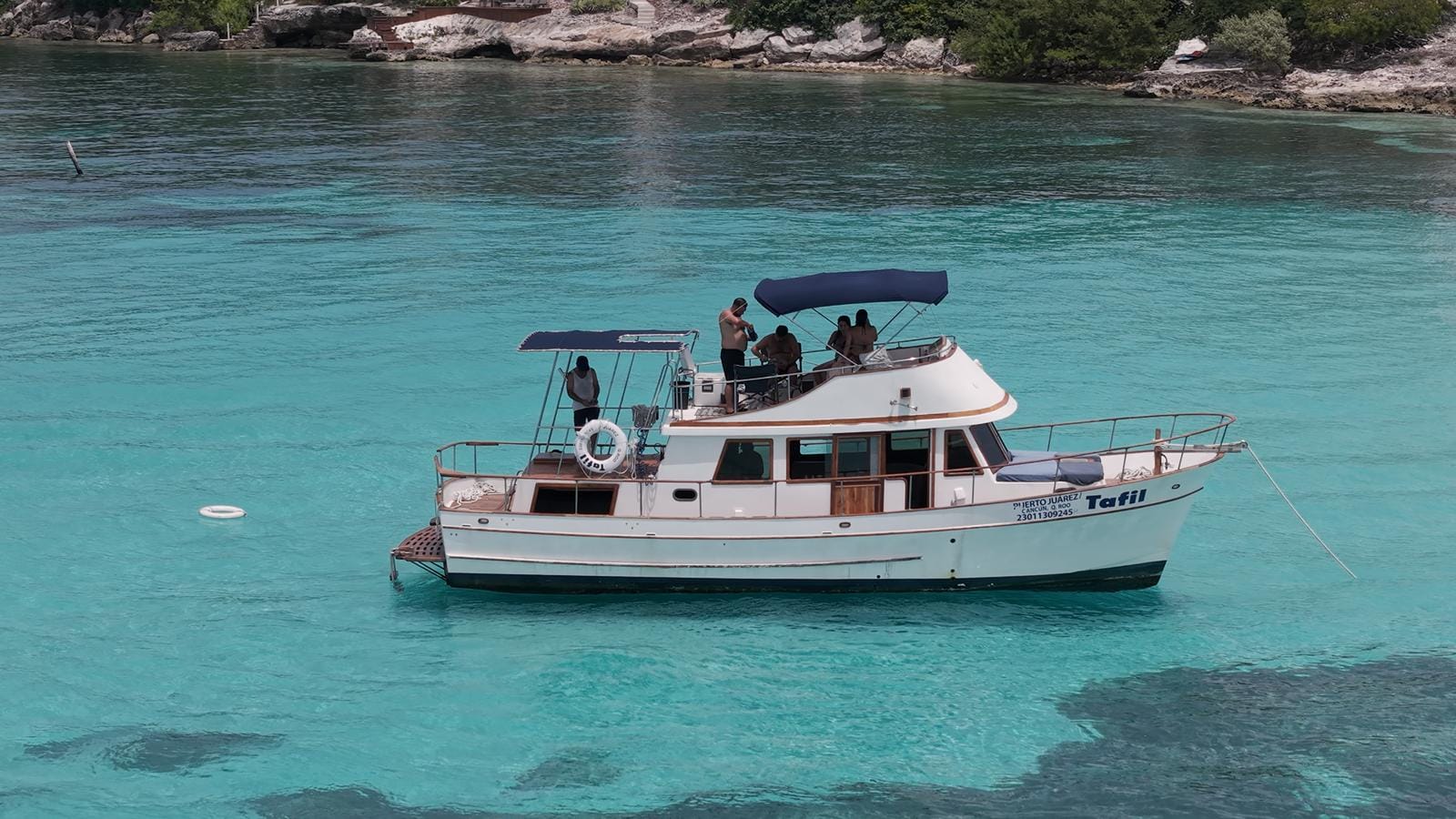 The Tafil anchored in the turquoise water near Punta Sur
