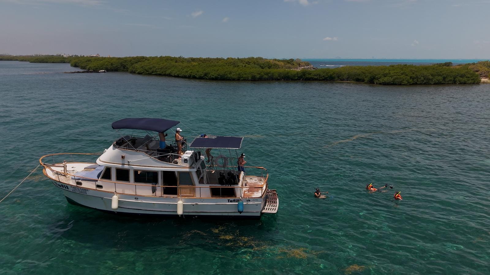 The Tafil anchored beside the mangrove shoreline of Laguna Macax