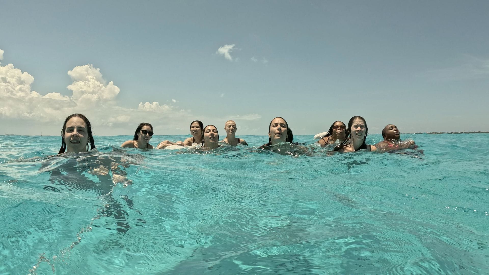 Group of guests swimming together in the shallow water of the Arenales
